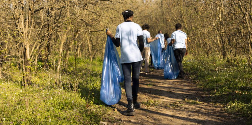 African american activist collecting trash and recycling in a blue bag